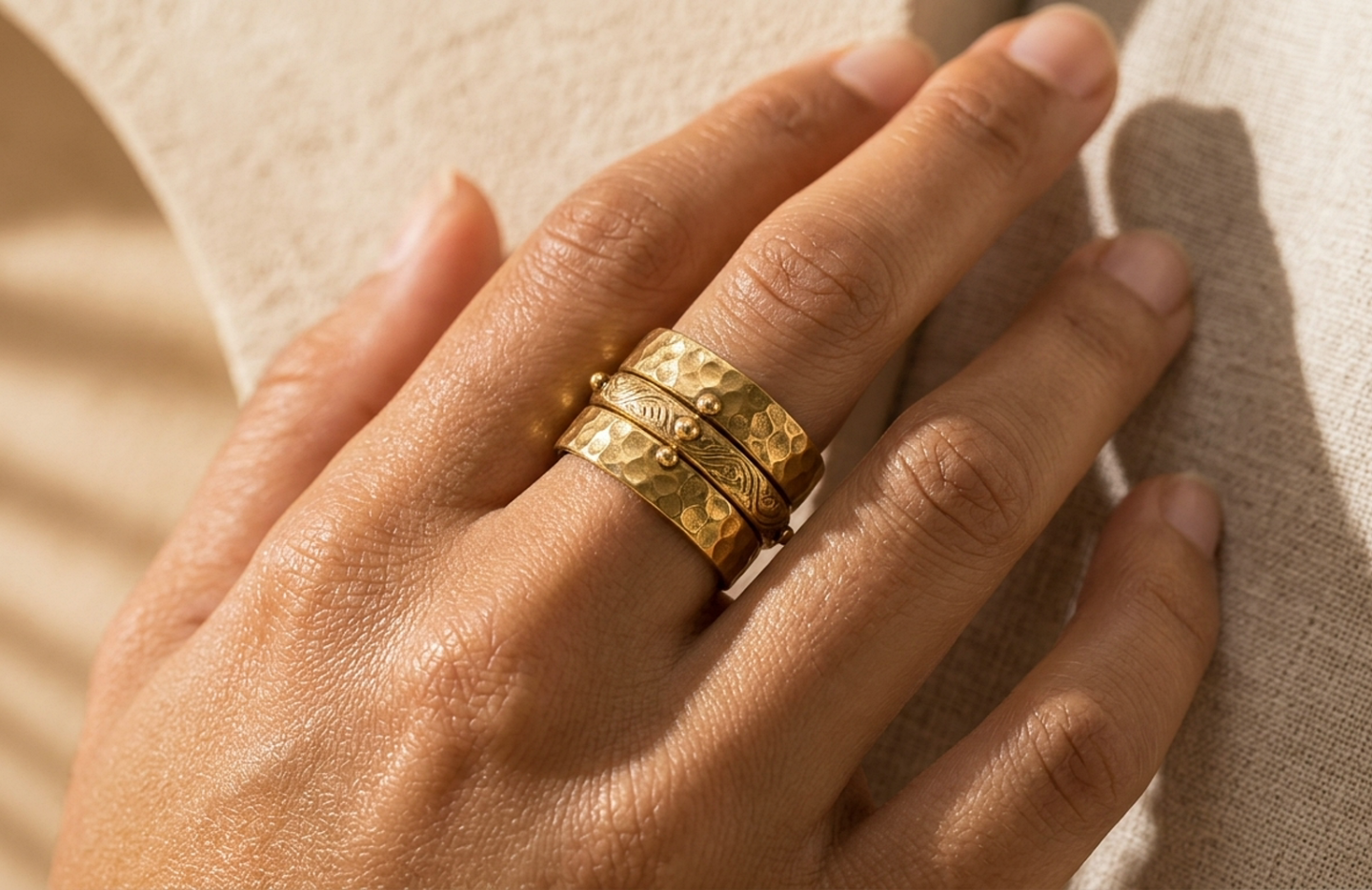 Detail editorial view of the Oru Hammered Brass Ring Set